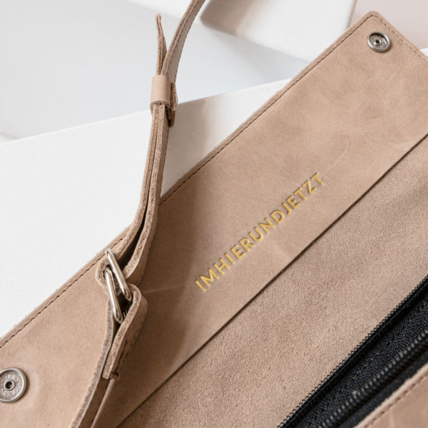 Detail Crossbody Bag TEA Large in light brown with embossing in gold.