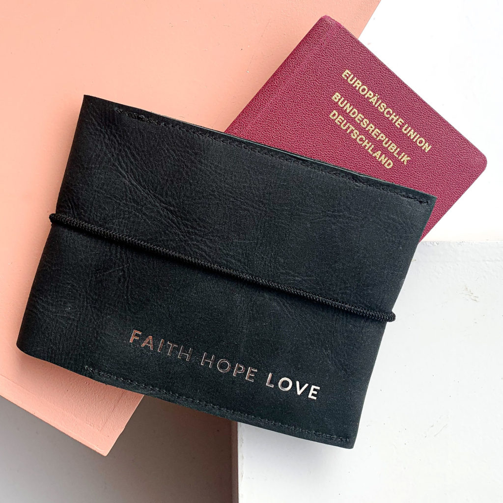 Family passport case EVE made of sustainable natural leather in charcoal with black closure band and individual embossing in silver