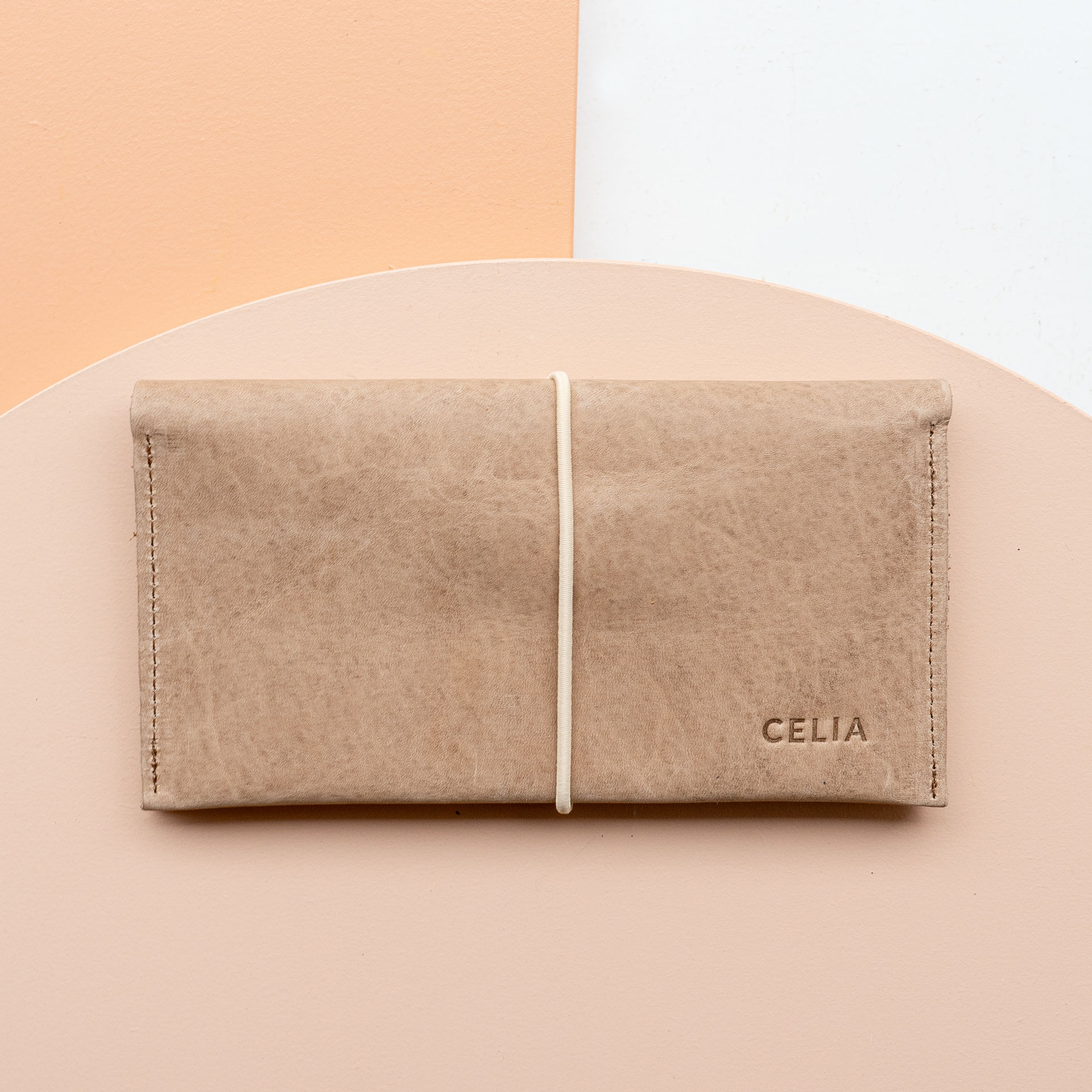 Wallet OLI XLARGE made of sustainable natural leather in light brown with cream-colored closure band and individual embossing 