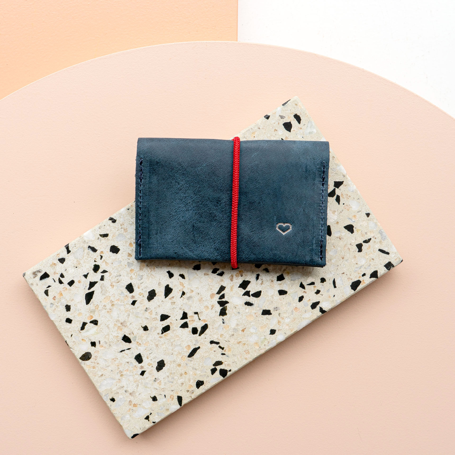 Wallet OLI MIDI natural leather in dark blue with red closure band and embossed heart in silver