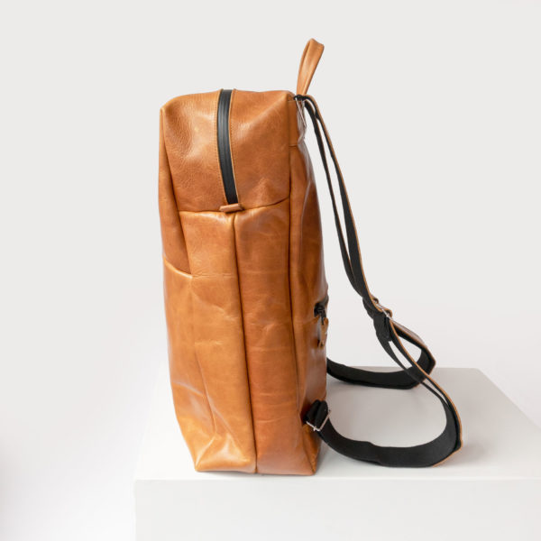 Side view of the backpack NEO LARGE natural leather in cognac oiled with wrap function