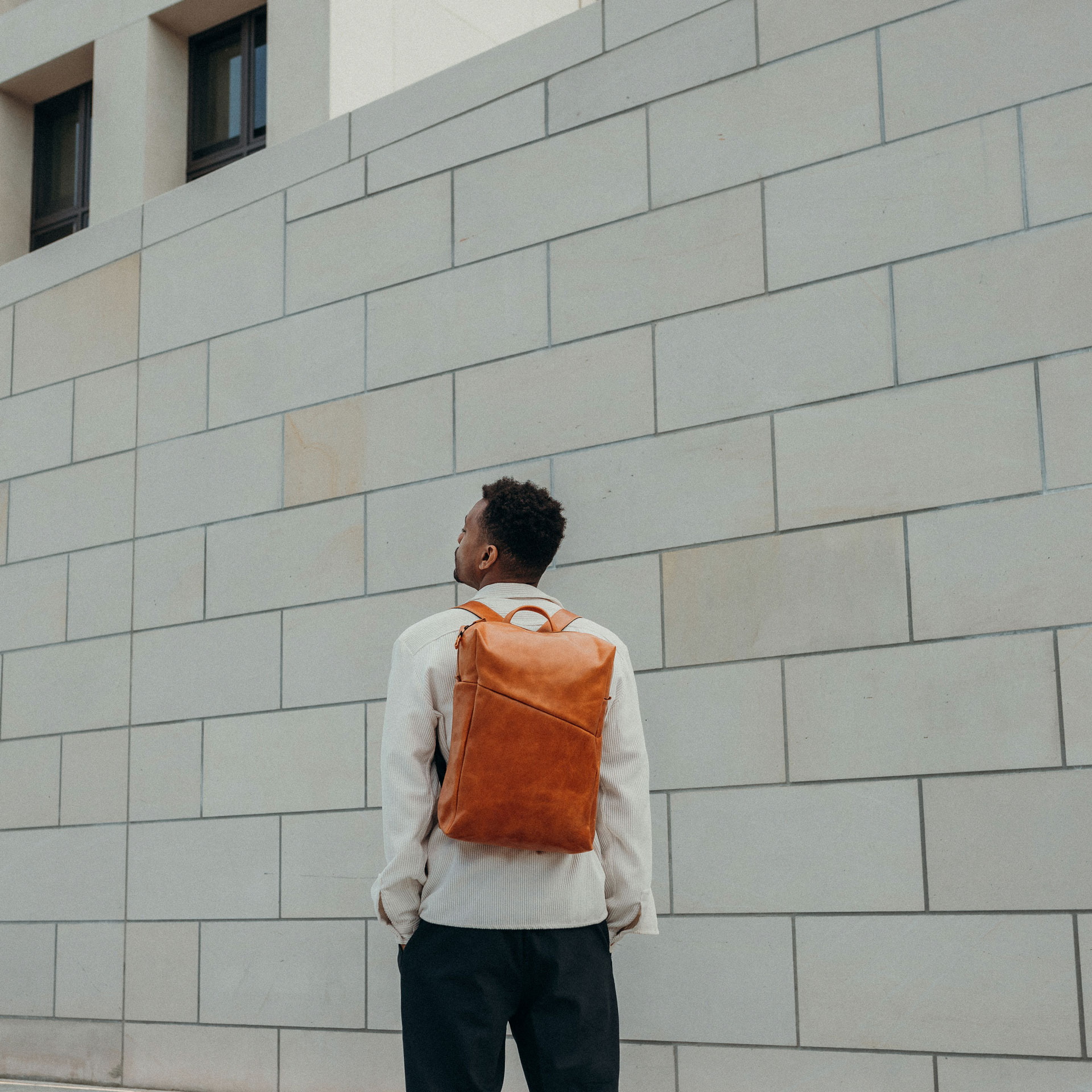 Our model Mack in the canyons of a city - on his back he carries our Daypack NEO Large.