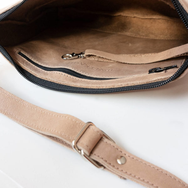 Detail view of the shoulder bag IDA made of natural leather in light brown from the inside with zipper compartment and key carabiner