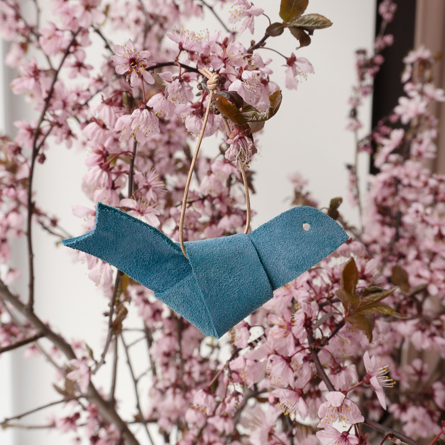 DIY Crafting with leather bird from natural leather in light blue