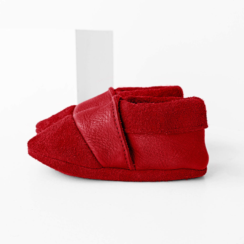 Side view of the MOQ walker shoes made of sustainable natural leather in red