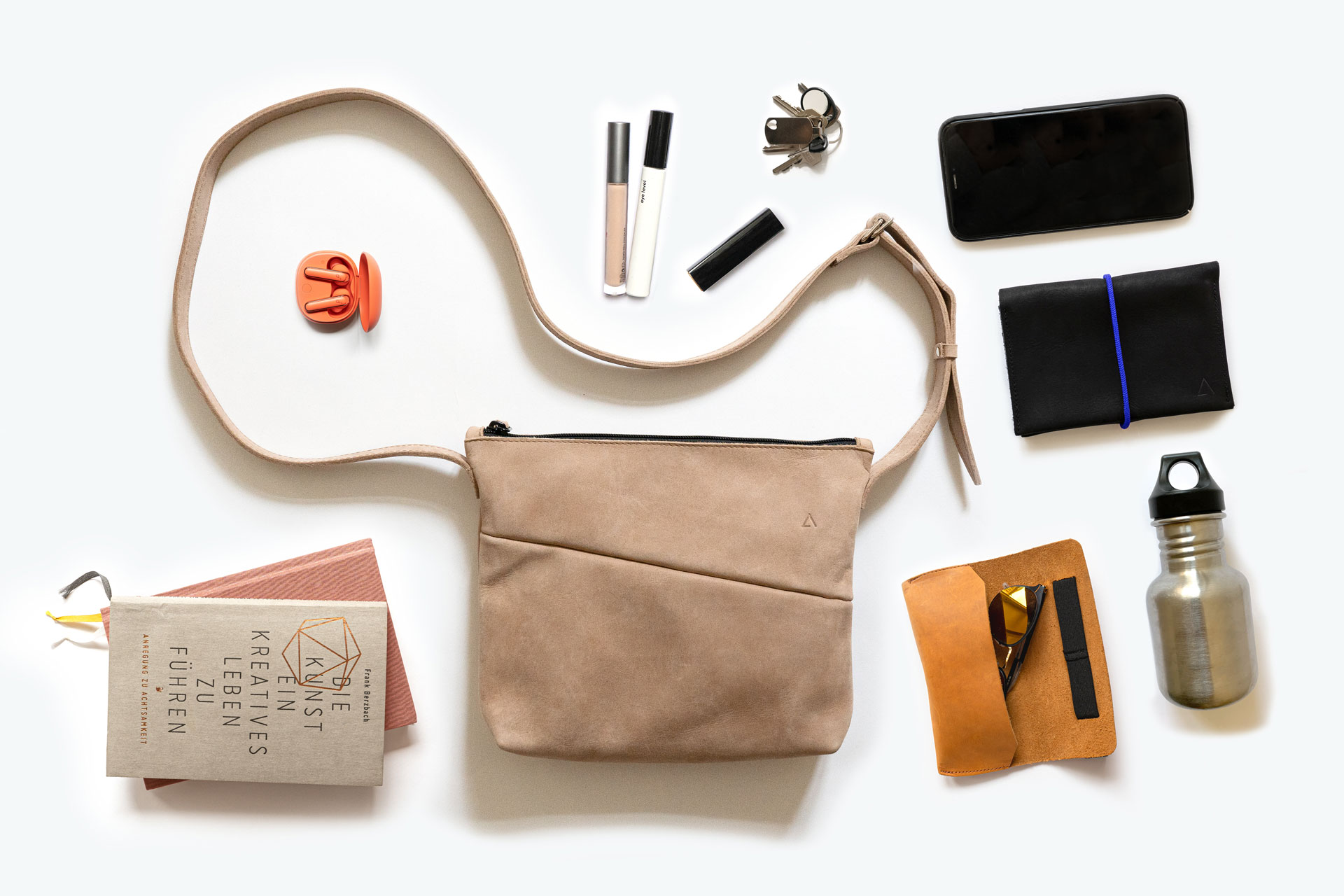 IDA is a small shoulder bag for everyday things like cell phone, keys and wallet. But there is also room for a book or a small water bottle.